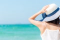 Summer Travel. Happy and Relax woman hand holding big hat on white sand beach, Royalty Free Stock Photo