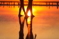 Summer travel holiday. Cropped photo of silhouette legs mom and child daughter walk together on sunset beach