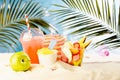 Summer travel, leisure and holiday background - picnic with cold drink, fresh fruit salad takeaway, sun hat, beach plays on hot. Royalty Free Stock Photo