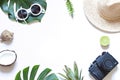 Summer travel tropical frame with a photo camera on the white background. Vacation concept flat lay. Royalty Free Stock Photo