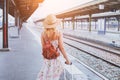 Summer travel, woman with suitcase waiting for her train Royalty Free Stock Photo