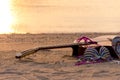 Summer traveling with guitar and Fashion woman swimsuit Bikini, fish star, sun glasses, hat on the sand beach in the holiday, Royalty Free Stock Photo