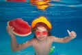 Summer travelling. Young boy swim and dive underwater. Under water portrait in swim pool. Child boy diving into a Royalty Free Stock Photo