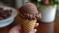 Summer treats, close-up of a hand gripping a chocolate ice cream cone, melting under the hot summer sun, a delicious and Royalty Free Stock Photo