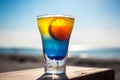 Glass of colorful cold fresh summer cocktail on wooden table with ocean view on background Royalty Free Stock Photo