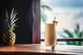 Glass of summer tropical cocktail and pineapple on wooden table with ocean view on background Royalty Free Stock Photo