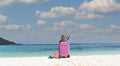 Summer  tropical stuff with Pink luggage on the white sand Beach background banner of the tropical travel concept Royalty Free Stock Photo