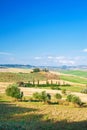 Summer Tuscan landscape, green field and blue sky Royalty Free Stock Photo