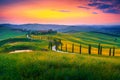 Summer Tuscany landscape at sunset with curved rural road, Italy