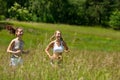 Summer - Two young woman jogging in a meadow Royalty Free Stock Photo