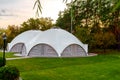 Summer-type cafe with cloth tent on the roof in the form of a dome with wooden entrance doors