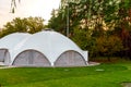 Summer-type cafe with cloth tent on the roof in the form of a dome with wooden entrance doors