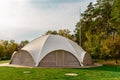 Summer-type cafe with cloth tent on the roof in the form of a dome with wooden entrance doors