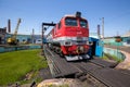 An old red locomotive stands on the railway tracks. Royalty Free Stock Photo