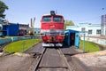 An old red locomotive stands on the railway tracks. Royalty Free Stock Photo