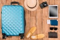 Summer vacation background with travel accessories. closed luggage, shoes, digital devices and passports