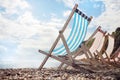 Summer vacation deck chairs on the beach at the seaside Royalty Free Stock Photo