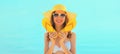 Summer vacation, beautiful happy smiling woman in yellow straw hat with flip flops on the beach on sea coast background on sunny Royalty Free Stock Photo