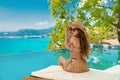 Summer Vacation. Beautiful Woman in beach hat enjoying sea view Royalty Free Stock Photo