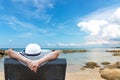 Summer Vacation. Beautiful young asian woman relaxing and happy on beach chair in holiday summertime, blue sky background. Royalty Free Stock Photo