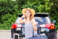 Summer vacation car road trip freedom concept. Happy woman cheering joyful during holiday travel with car. Royalty Free Stock Photo