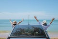 Family car trip at the sea, Woman and child cheerful raising their hands up and feeling happiness. Royalty Free Stock Photo