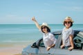 Family car trip at the sea, Woman and child cheerful raising their hands up and feeling happiness.