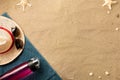 Summer vacation composition. Flip flops, hat and bottle of water on sand background