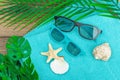 Summer vacation concept. Bath towel, sunglasses, marine decor