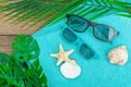 Summer vacation concept. Bath towel, sunglasses, marine decor