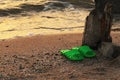 Summer vacation concept. green Flipflops on a sandy ocean beach.Wild uncomfortable beach. The sunset, the beach, the Royalty Free Stock Photo