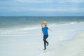 Summer vacation concept. Happy little kid running on the beach, walking on sea sandy beach. Travel adventure kids Royalty Free Stock Photo