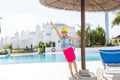 Summer vacation concept. Little cute girl holding hands up near a swimming pool Royalty Free Stock Photo