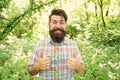 Summer vacation concept. Man bearded hipster green trees background. Emotional nature lover. Guy relax in summer nature Royalty Free Stock Photo