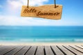 Summer vacation concept sea beach blurry background. Hello summer wooden sign