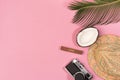 Summer vacation concept. stylish hat, retro photo camera and green palm leaves on pink background, flat lay Royalty Free Stock Photo