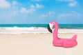 Summer Vacation Concept. Summer Swimming Pool Inflantable Rubber Pink Flamingo Toy on an Ocean Deserted Coast. 3d Rendering