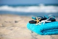 Summer vacation concept towel with sunglasses and starfish on sandy tropical beach Royalty Free Stock Photo