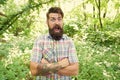 Summer vacation concept. United with environment. Man bearded hipster green trees background. Emotional nature lover Royalty Free Stock Photo