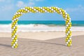 Summer Vacation Concept. White and Yellow Balloons in Shape of Arc, Gate or Portal on an Ocean Deserted Coast. 3d Rendering