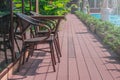 Wooden weave brown chairs and table place on terrace beside swimming pool.