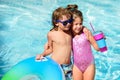 Summer vacation. Couple of kids rest in swimming pool. Royalty Free Stock Photo