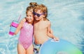 Summer vacation. Couple of kids rest in swimming pool. Royalty Free Stock Photo