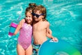 Summer vacation. Couple of kids rest in swimming pool. Royalty Free Stock Photo