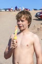 Summer vacation: cute teen with icecream at the beach Royalty Free Stock Photo