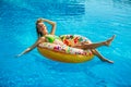 Woman in bikini on the inflatable mattress in the swimming pool. Royalty Free Stock Photo