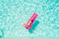Summer Vacation. Enjoying suntan woman in bikini on the inflatable mattress in the swimming pool Royalty Free Stock Photo