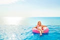 Summer Vacation. Woman in bikini on the inflatable donut mattress in the SPA swimming pool.