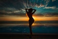 Summer Vacation. Silhouette of beauty dancing woman on sunset near the pool with ocean view. Royalty Free Stock Photo