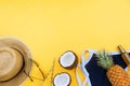 Summer vacation flatlay with straw hat, swimsuit, coconut halves, body oil and glasses